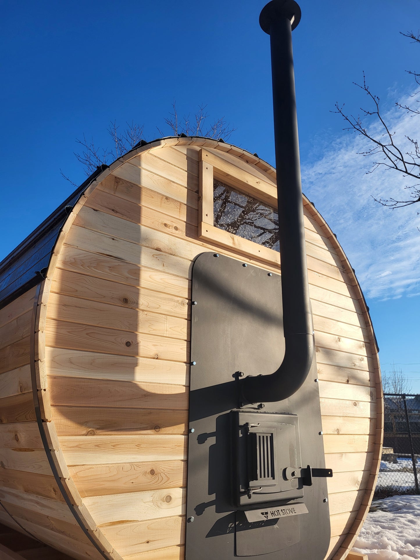 Exterior fed wood sauna stove
