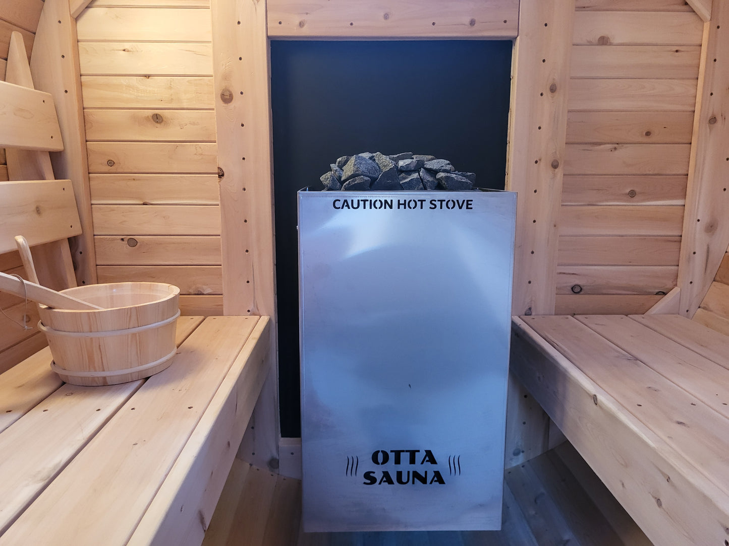 Exterior fed wood sauna stove