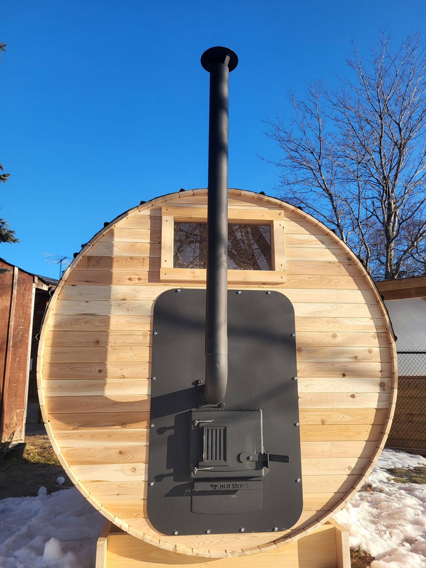 Exterior fed wood sauna stove