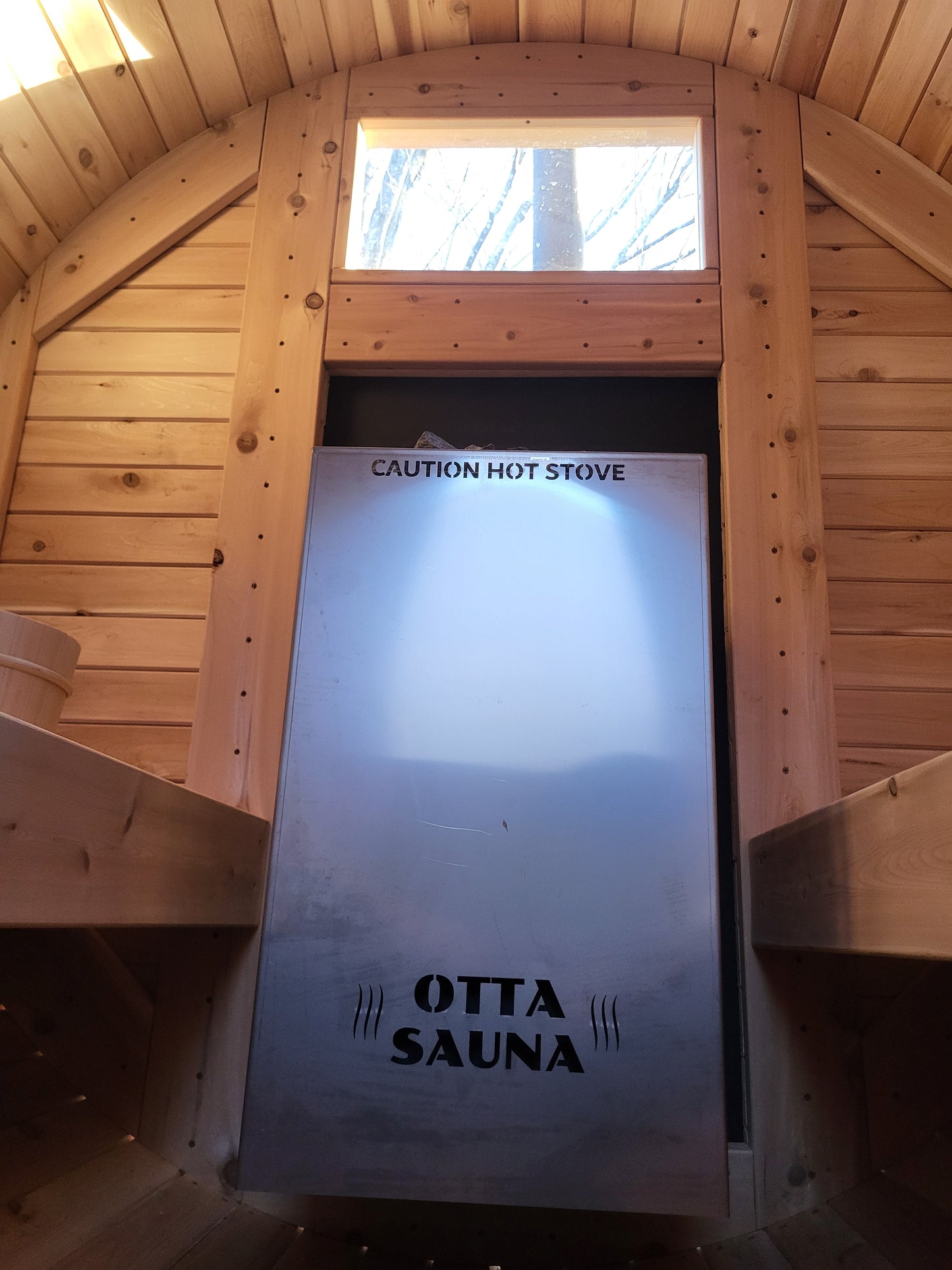 Exterior fed wood sauna stove